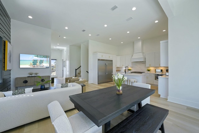 dining area with sink and light hardwood / wood-style floors