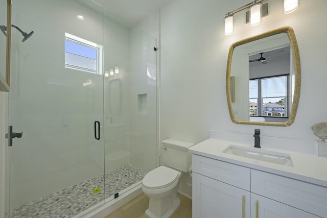 bathroom with toilet, walk in shower, a wealth of natural light, and vanity