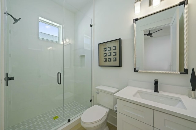 bathroom featuring toilet, a shower with shower door, and vanity