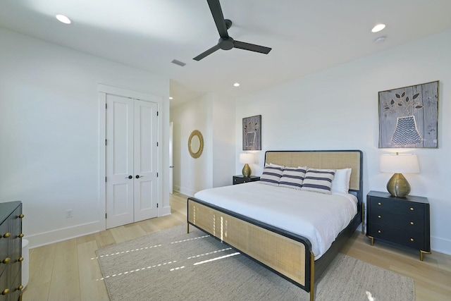 bedroom featuring light hardwood / wood-style floors, a closet, and ceiling fan