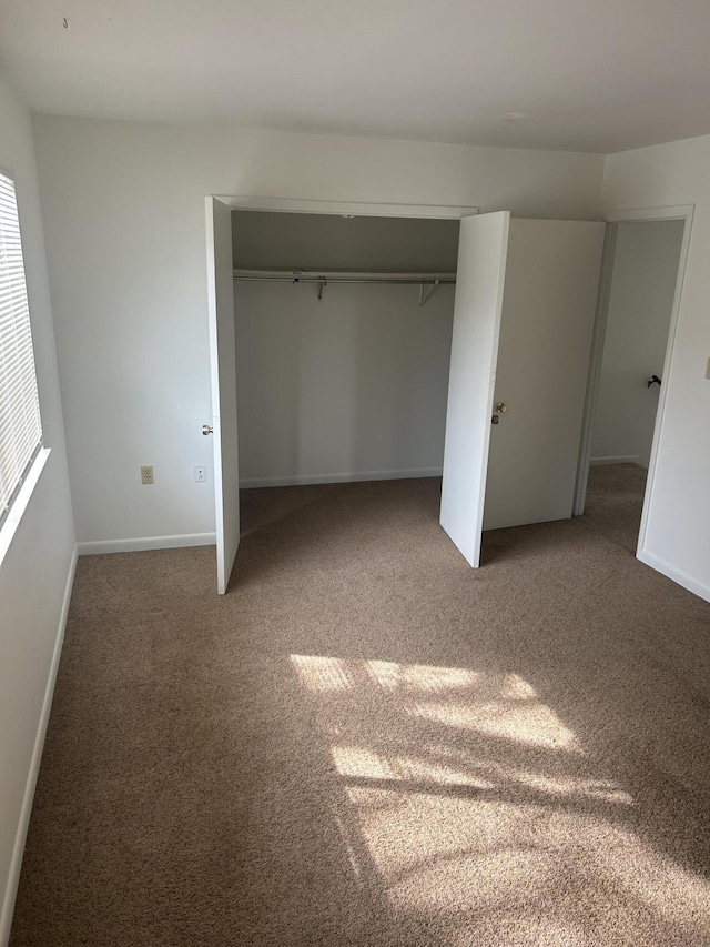 unfurnished bedroom featuring a closet and carpet