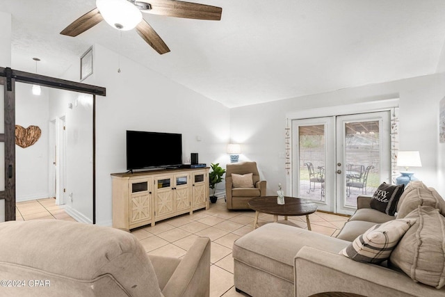 5620 Pinetree Ave, Panama City Beach, FL 32408 - living room featuring french doors, light tile patterned flooring, lofted ceiling, ceiling fan, and a barn door