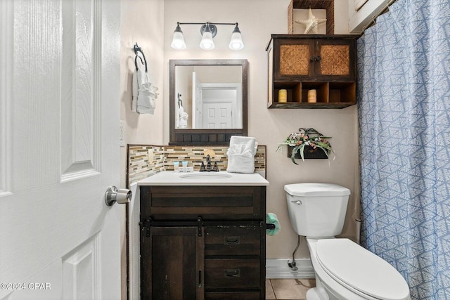 5620 Pinetree Ave, Panama City Beach, FL 32408 - bathroom featuring vanity, backsplash, and toilet