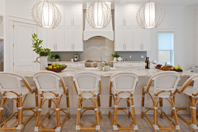 kitchen with white cabinetry and pendant lighting