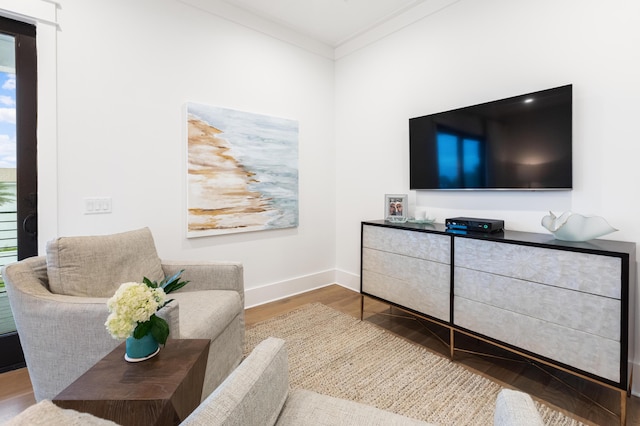 living room with crown molding and hardwood / wood-style flooring