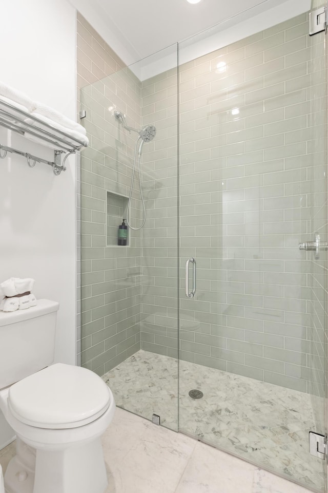 bathroom with an enclosed shower and toilet