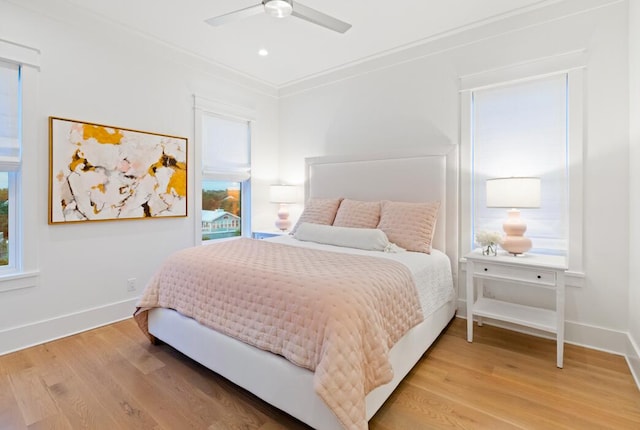 bedroom featuring ceiling fan, ornamental molding, and hardwood / wood-style floors