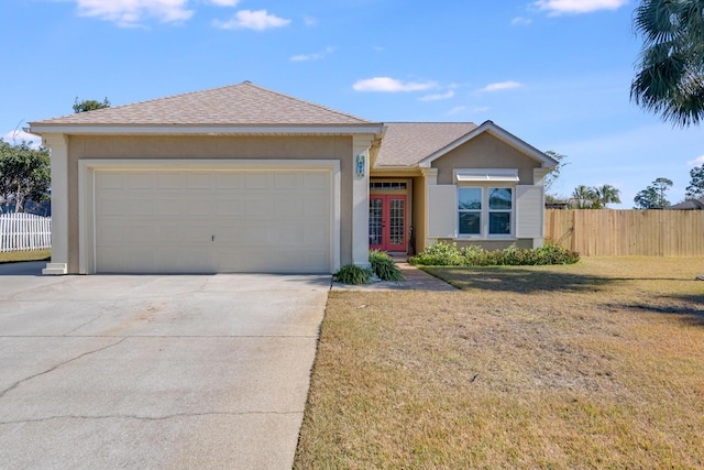 ranch-style home with a garage, a front yard, and french doors