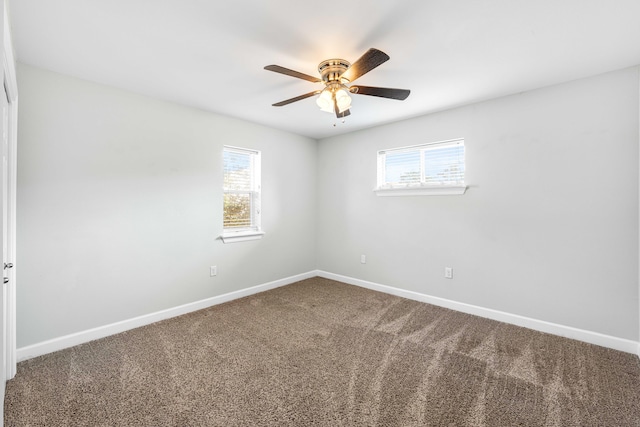 spare room featuring ceiling fan, plenty of natural light, and carpet floors