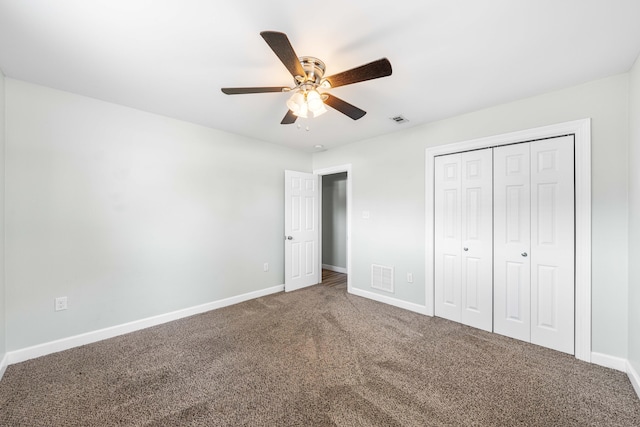 unfurnished bedroom featuring carpet floors, ceiling fan, and a closet