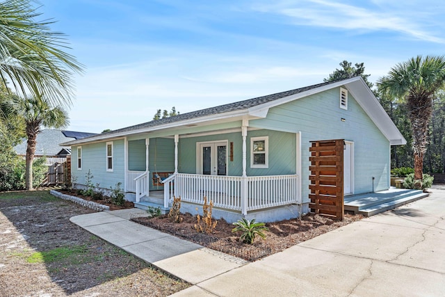 view of front of property with covered porch and french doors