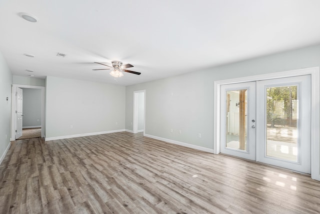 spare room featuring french doors, ceiling fan, and light hardwood / wood-style flooring