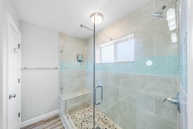 bathroom with walk in shower and hardwood / wood-style flooring