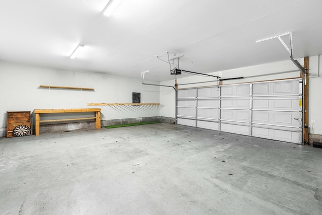 garage with a garage door opener and electric panel