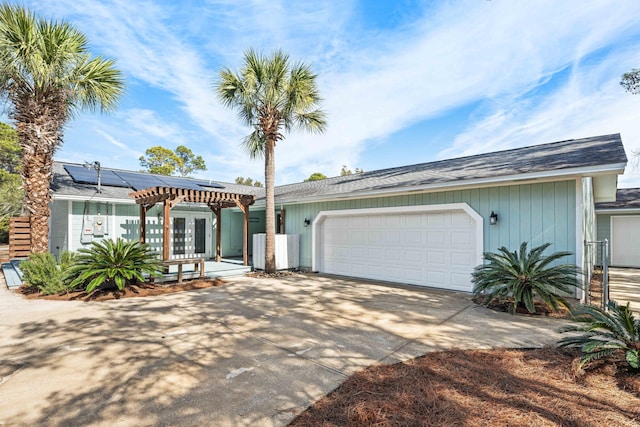 ranch-style house with a garage, french doors, and solar panels