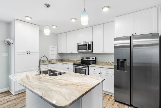 kitchen with white cabinetry, sink, decorative light fixtures, and appliances with stainless steel finishes