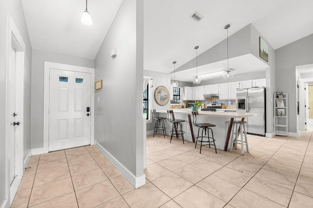 tiled foyer with lofted ceiling