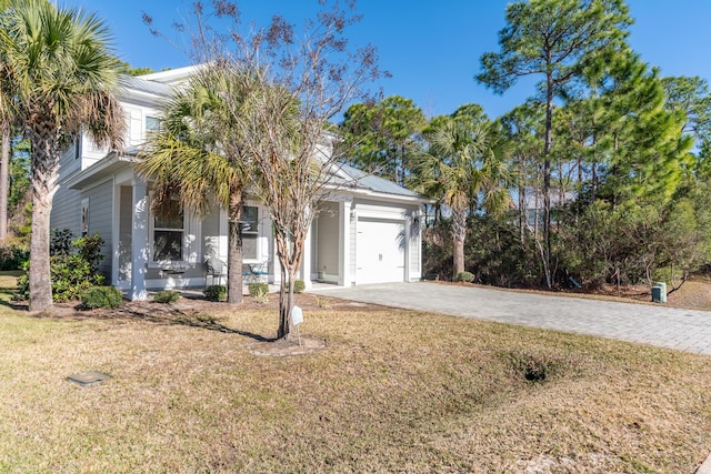 view of front of property featuring a front yard and a garage