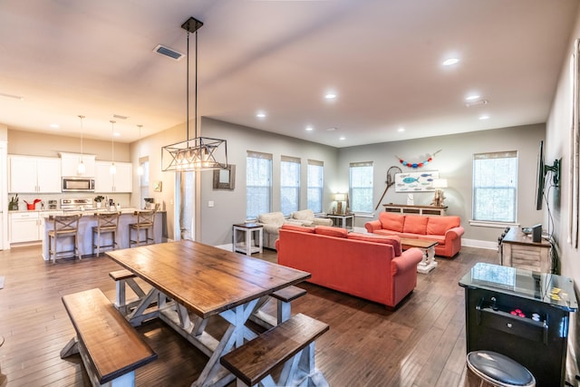 dining room featuring dark hardwood / wood-style flooring and plenty of natural light