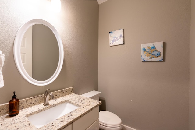 bathroom with toilet and vanity