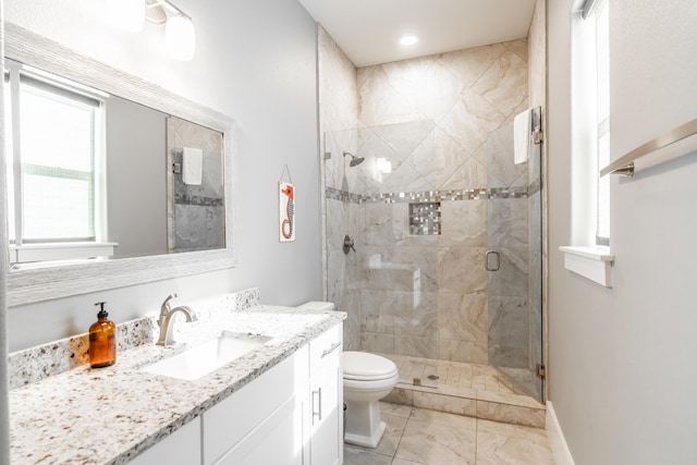 bathroom with an enclosed shower, vanity, and toilet