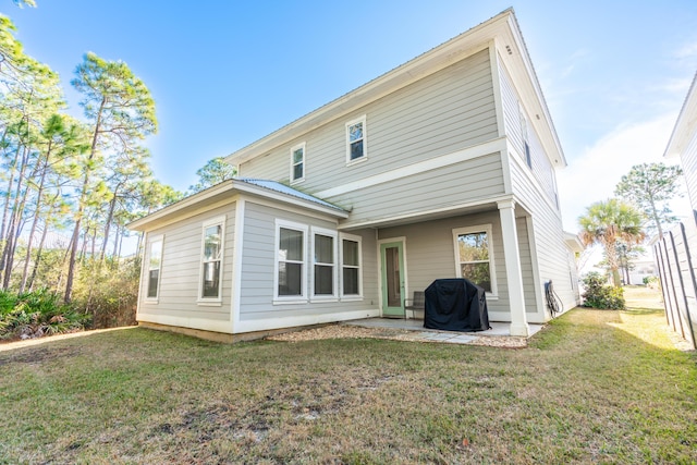 back of property featuring a yard and a patio