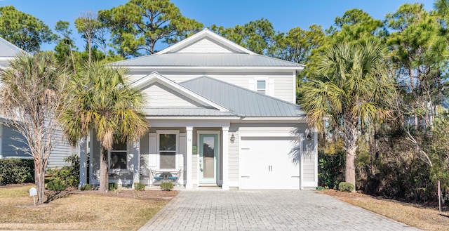 view of front of property featuring covered porch and a garage