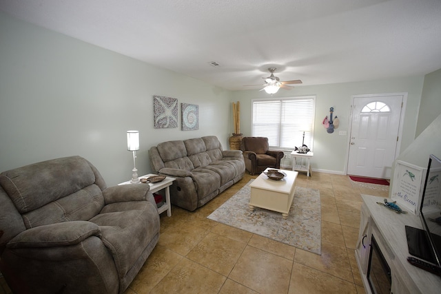 tiled living room featuring ceiling fan