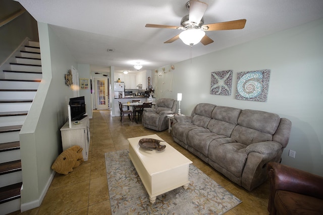 tiled living room with ceiling fan