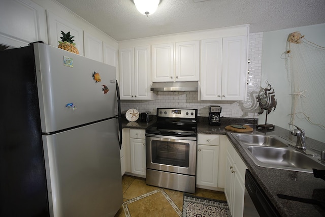 kitchen with a textured ceiling, appliances with stainless steel finishes, white cabinetry, and sink