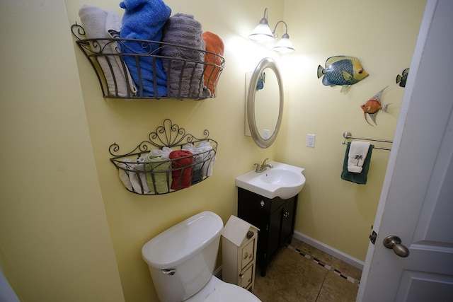 bathroom featuring toilet, tile patterned floors, and vanity