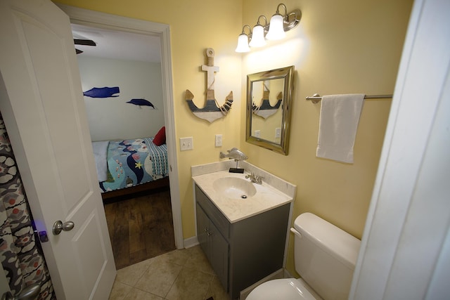 bathroom featuring toilet, vanity, and tile patterned floors