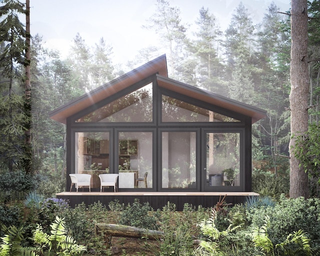 view of outbuilding featuring a sunroom