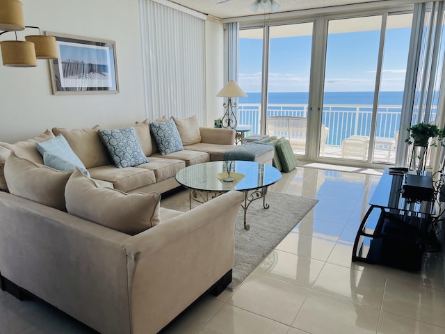 living room with light tile patterned floors, floor to ceiling windows, and a water view