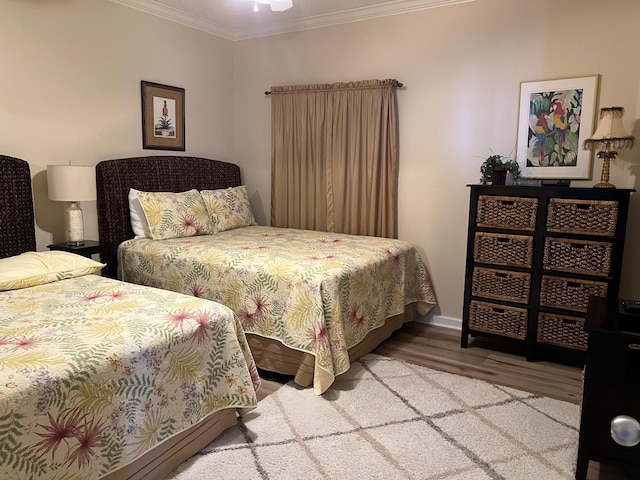 bedroom featuring ornamental molding and hardwood / wood-style floors