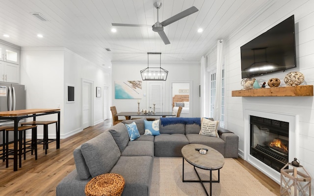 living room featuring crown molding, ceiling fan, wooden ceiling, and light wood-type flooring