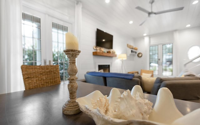 living room featuring ceiling fan and a wealth of natural light