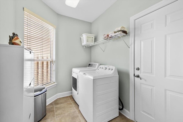 laundry room featuring a wealth of natural light and separate washer and dryer