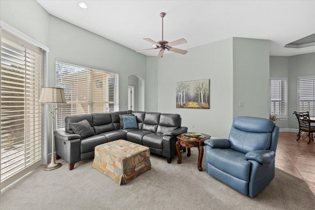 carpeted living room with ceiling fan