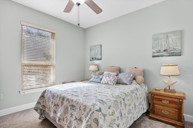 carpeted bedroom with ceiling fan and multiple windows