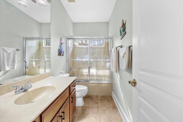 full bathroom with toilet, shower / bath combination with glass door, and vanity