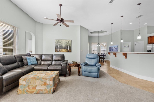 living room with light tile patterned flooring, a high ceiling, and ceiling fan