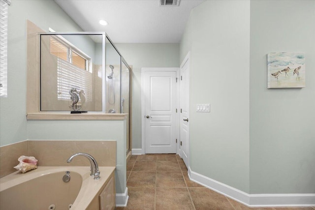 bathroom featuring plus walk in shower and tile patterned flooring