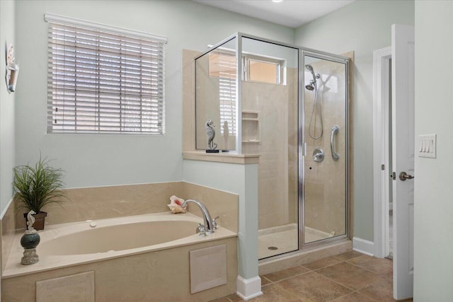 bathroom with tile patterned floors and independent shower and bath