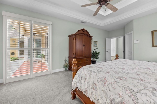 carpeted bedroom featuring crown molding, a tray ceiling, and ceiling fan