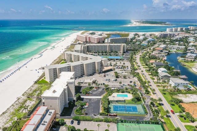 drone / aerial view with a water view and a beach view