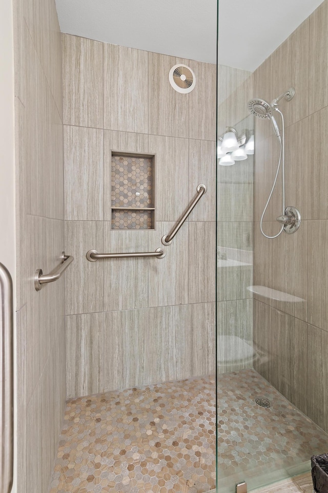 bathroom with a tile shower