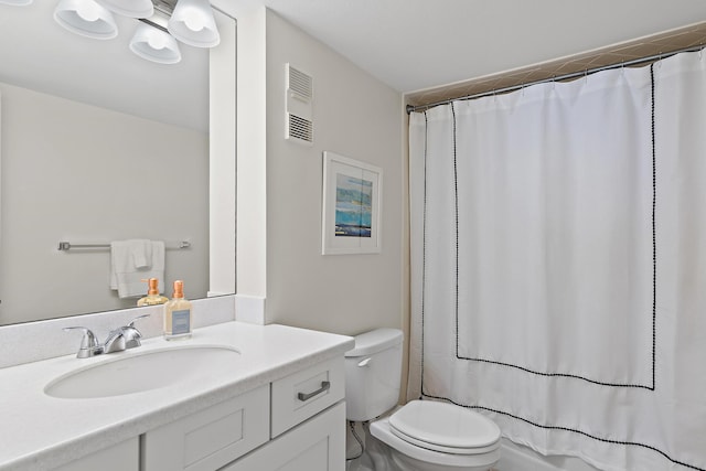 bathroom with vanity, a shower with shower curtain, and toilet