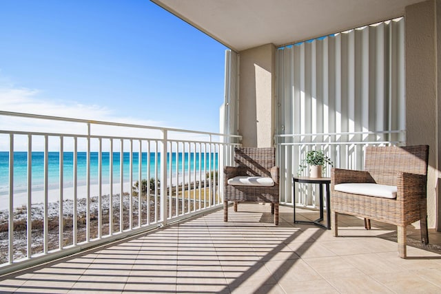 balcony with a beach view and a water view