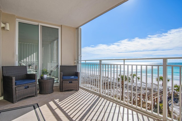 balcony with a view of the beach and a water view